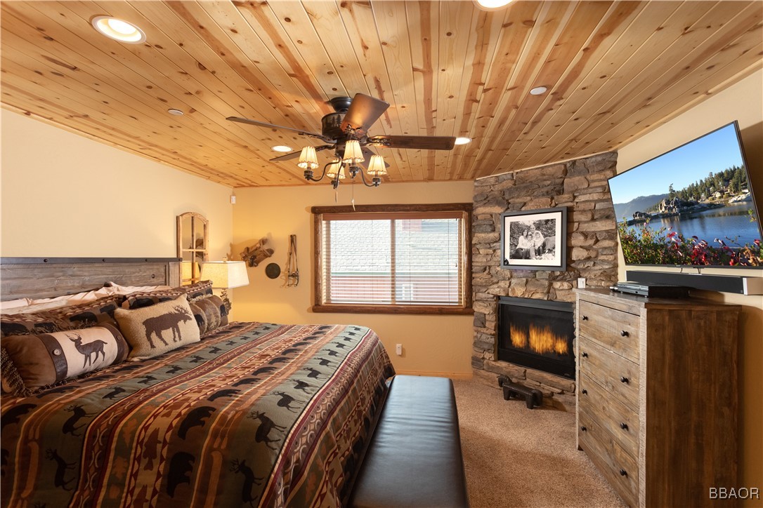 1389 Flintridge Avenue Big Bear City, CA 92314 - Photo 10 of 21 a bedroom with a bed a flat screen tv and chandelier