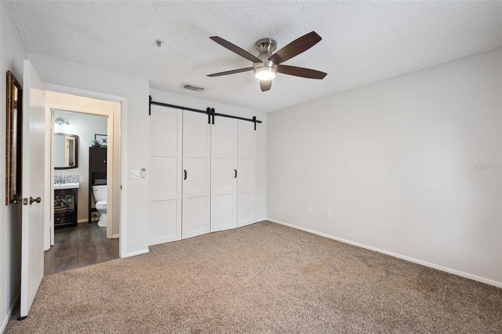 112 Reserve Circle, Unit 212 Oviedo, FL 32765 - Photo 13 of 54 a view of a livingroom with a ceiling fan & a ceiling fan