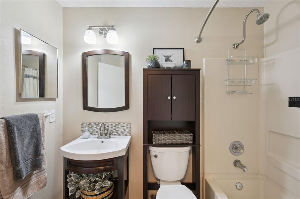112 Reserve Circle, Unit 212 Oviedo, FL 32765 - Photo 15 of 54 a bathroom with a toilet sink and mirror