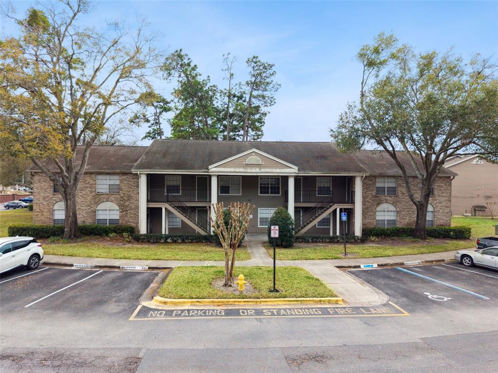 112 Reserve Circle, Unit 212 Oviedo, FL 32765 - Photo 18 of 54 a front view of a house with swimming pool and yard