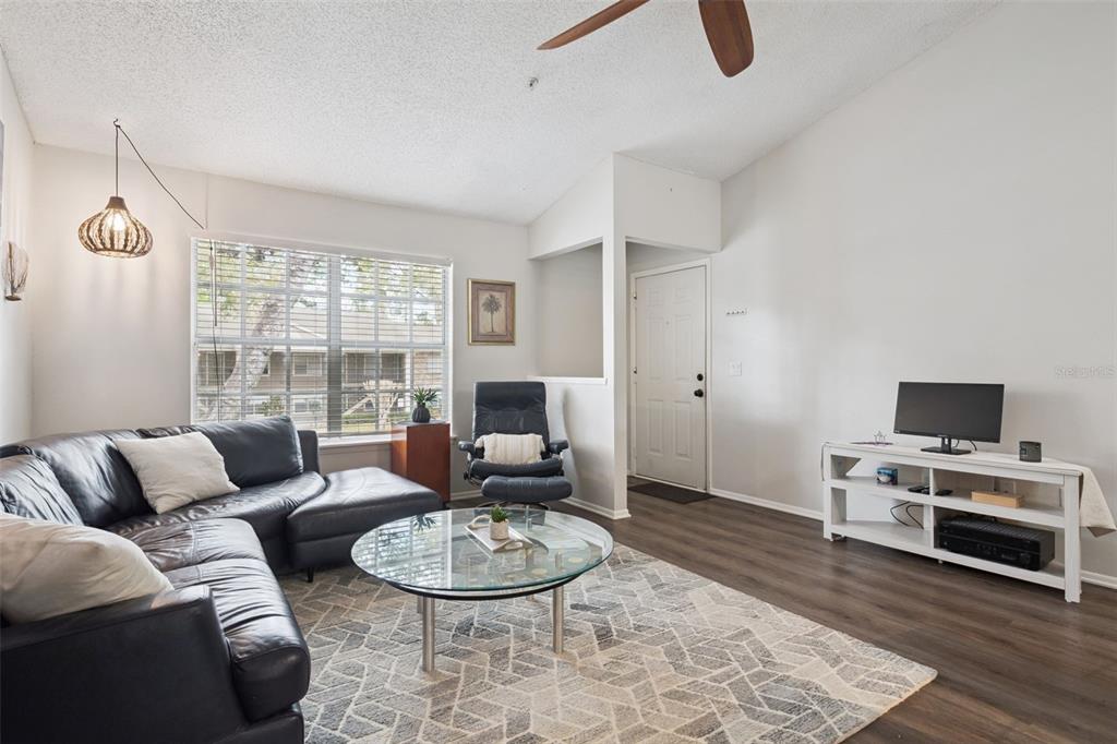 112 Reserve Circle, Unit 212 Oviedo, FL 32765 - Photo 2 of 54 a living room with furniture and a flat screen tv