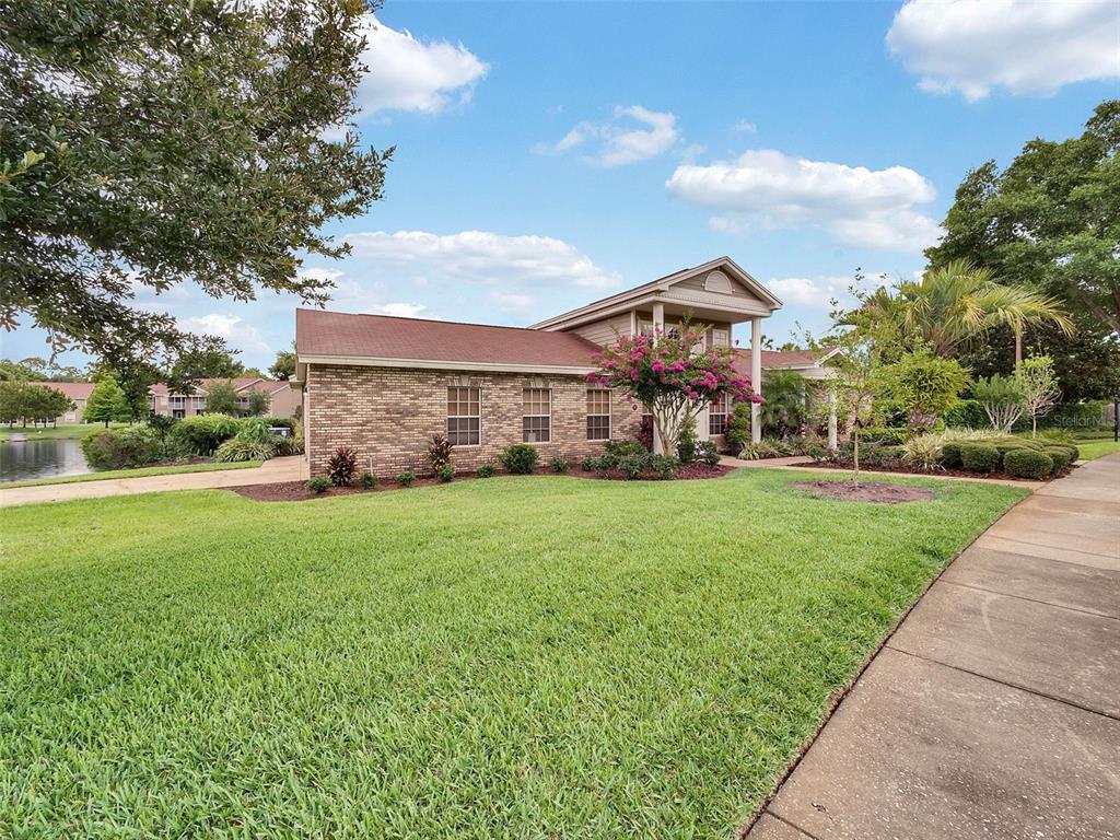 112 Reserve Circle, Unit 212 Oviedo, FL 32765 - Photo 23 of 54 a front view of house with yard and trees in the background