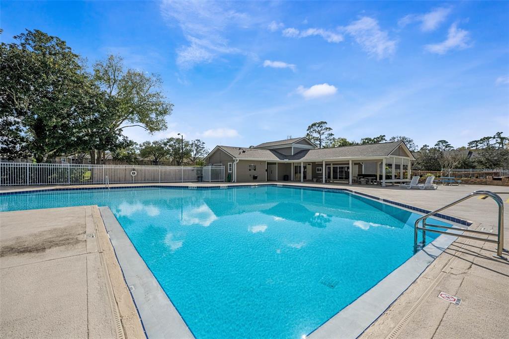 112 Reserve Circle, Unit 212 Oviedo, FL 32765 - Photo 28 of 54 a view of a swimming pool with a yard