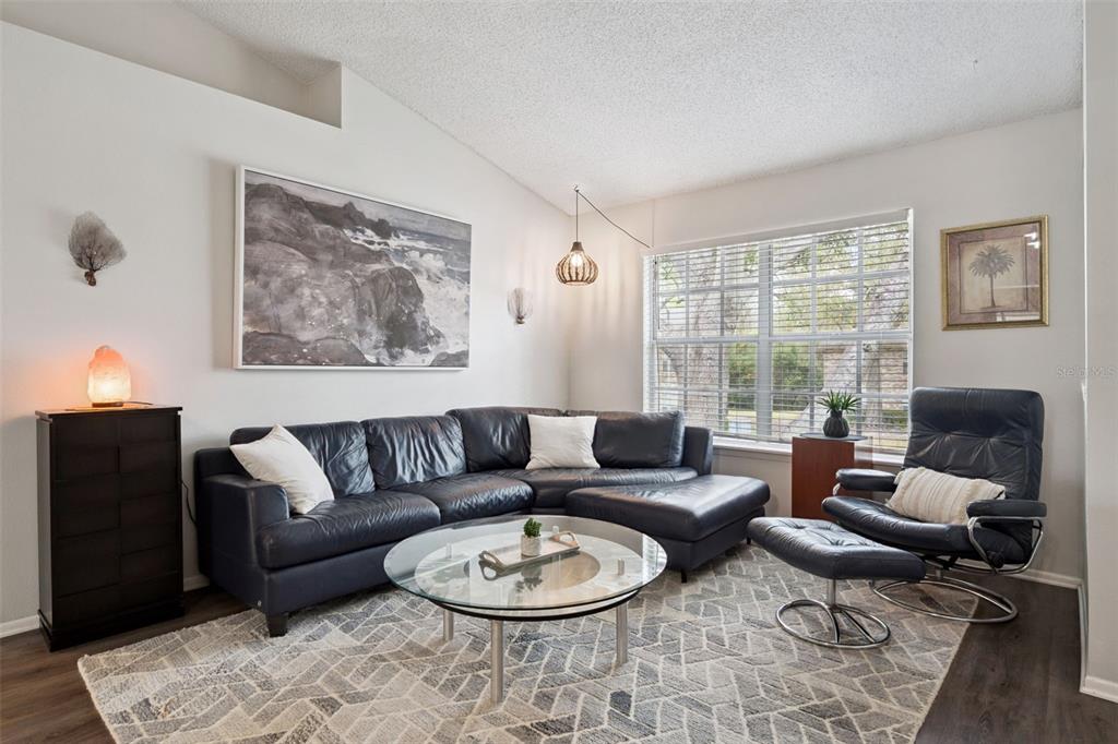 112 Reserve Circle, Unit 212 Oviedo, FL 32765 - Photo 3 of 54 a living room with furniture a large window and a table