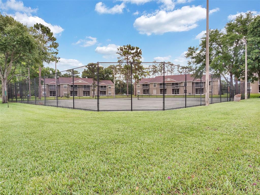 112 Reserve Circle, Unit 212 Oviedo, FL 32765 - Photo 32 of 54 a view of a field of grass and trees