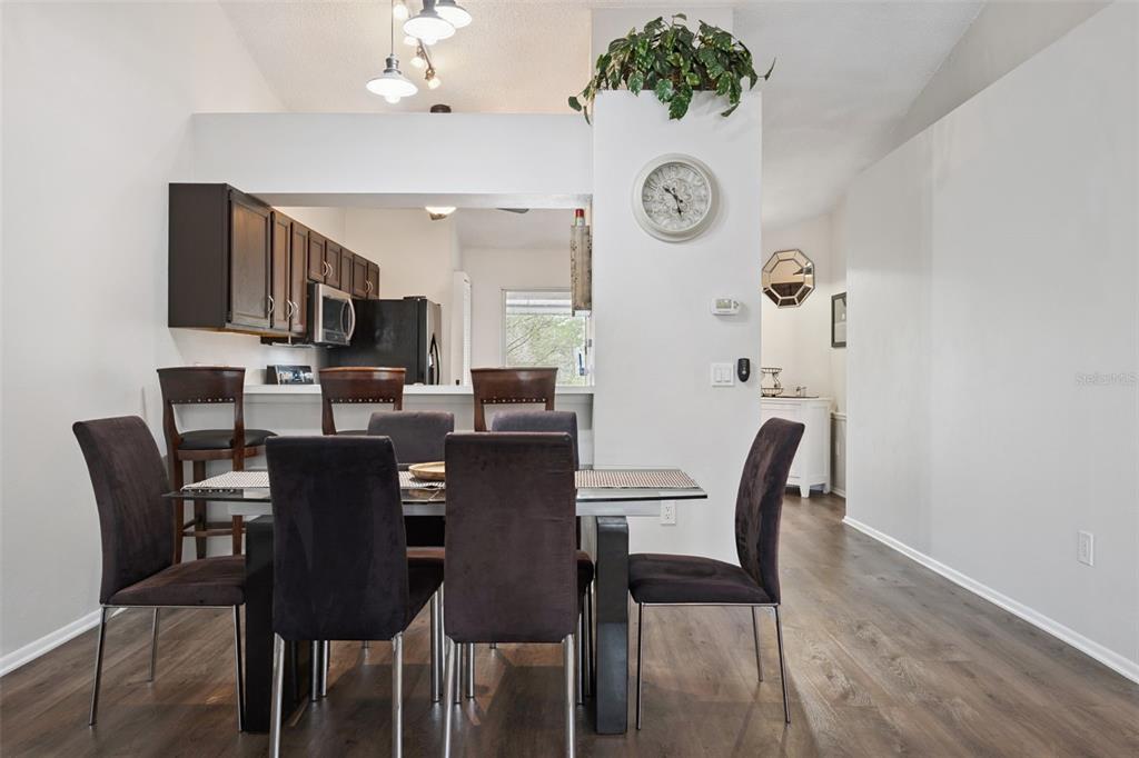112 Reserve Circle, Unit 212 Oviedo, FL 32765 - Photo 6 of 54 a view of a dining room with furniture and wooden floor