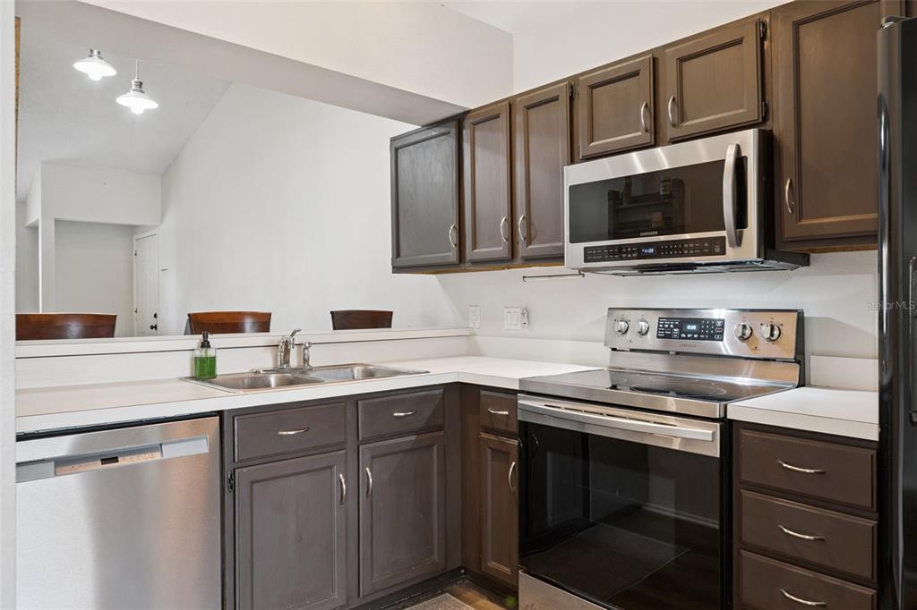 112 Reserve Circle, Unit 212 Oviedo, FL 32765 - Photo 7 of 54 a kitchen with a sink stove and microwave