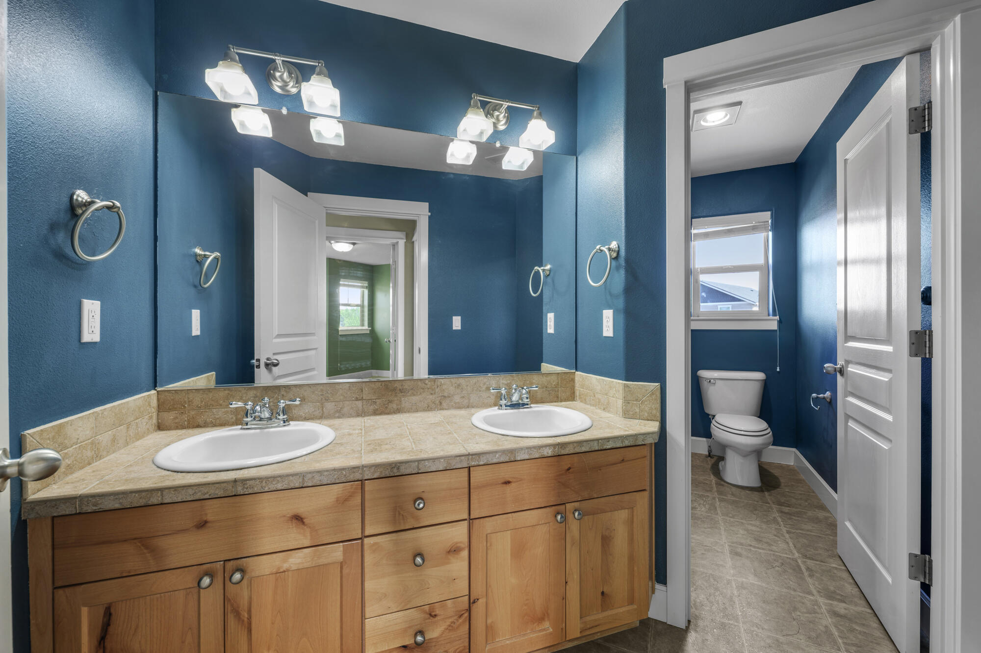 1402 Northeast Hudspeth Road Prineville, OR 97754 - Photo 25 of 36 a bathroom with a sink double vanity and a toilet