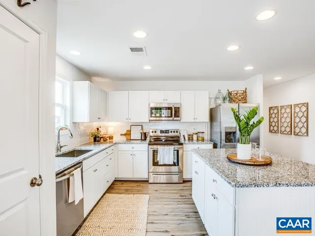 a kitchen with sink a stove and cabinets