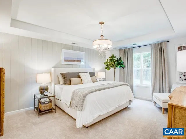 a spacious bedroom with a bed and a window