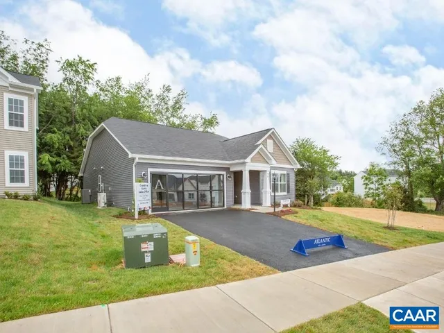a front view of a house with swimming pool having outdoor seating