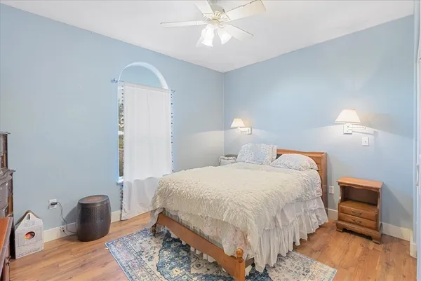 a bedroom with a bed and a chandelier