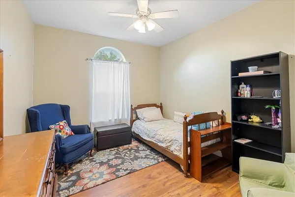 a bedroom with furniture and a window