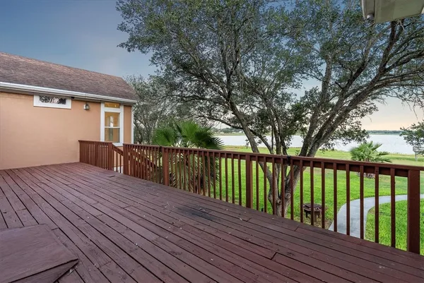 a view of balcony with wooden floor and fence