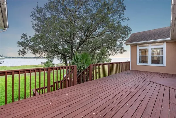 a balcony with wooden floor and fence
