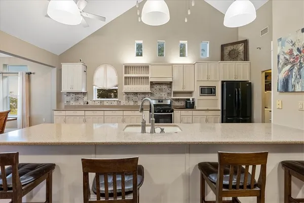 a kitchen with stainless steel appliances a sink a stove and a refrigerator