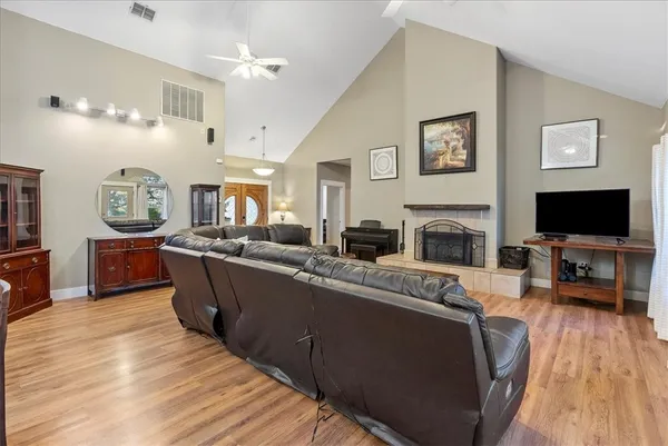 a living room with furniture a flat screen tv and a fireplace