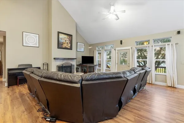 a living room with furniture a flat screen tv and a fireplace