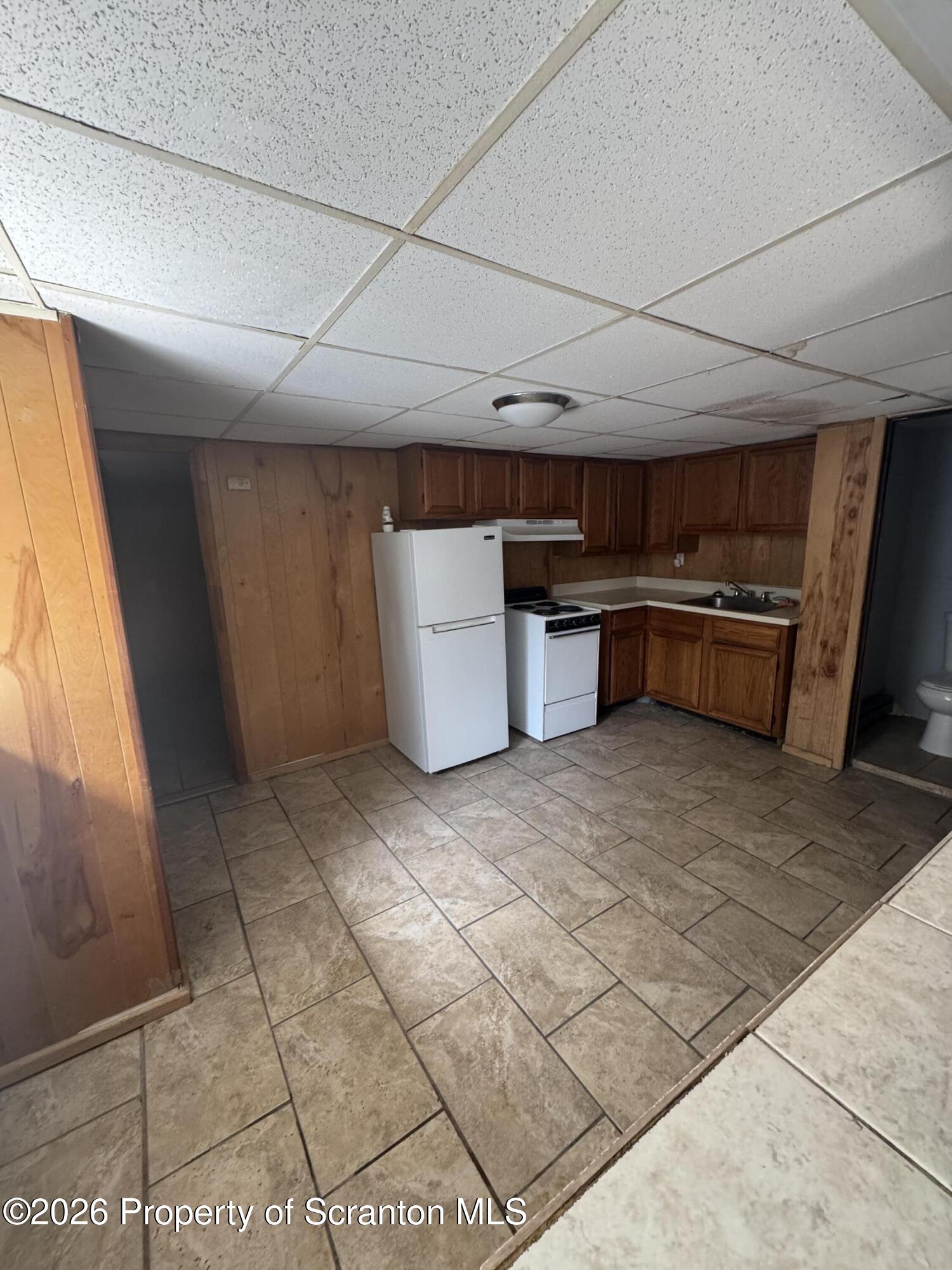 906 West Market Street Scranton, PA 18508 - Photo 4 of 10 a kitchen with stainless steel appliances a sink a counter top space and cabinets