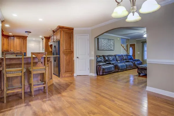 a kitchen with stainless steel appliances kitchen island granite countertop a table and chairs in it