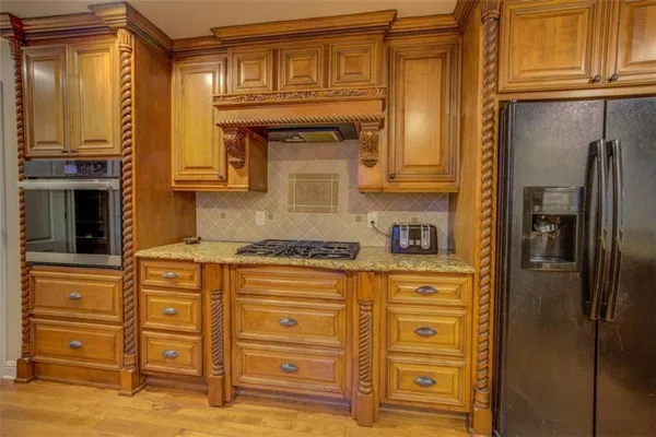 a kitchen with stainless steel appliances granite countertop wooden cabinets a sink and dishwasher