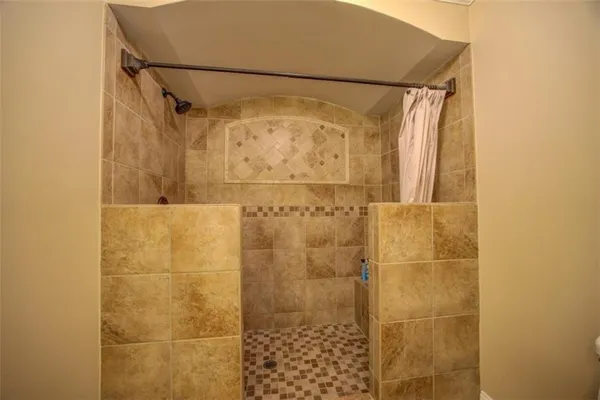 a bathroom with a granite countertop toilet sink and a mirror