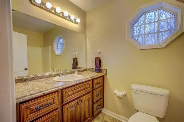 a bed sitting in a bedroom next to a bathroom