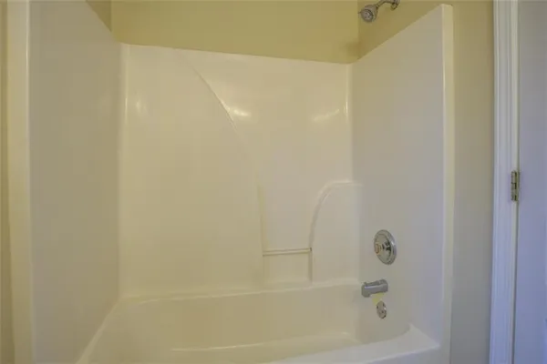 an empty room with closet and a bathroom