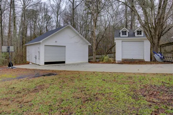 a front view of house with yard and trees