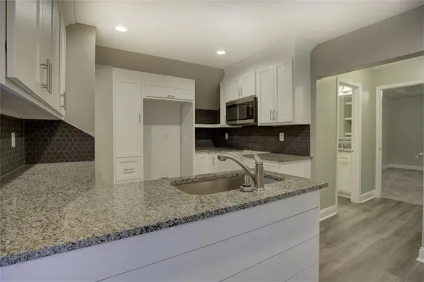 a view of a house with a yard and garage