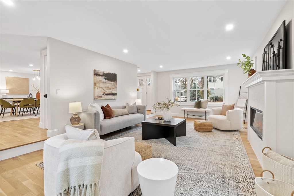 56 Valentine Road Arlington, MA 02476 - Photo 11 of 42 a living room with furniture fireplace and a large window
