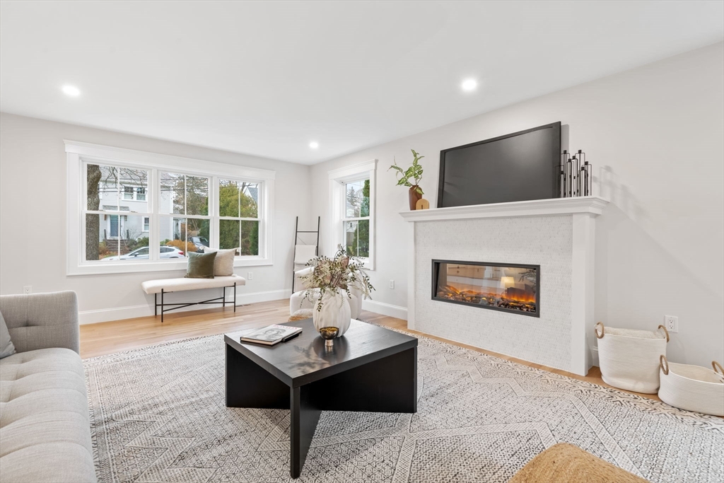 56 Valentine Road Arlington, MA 02476 - Photo 12 of 42 a living room with furniture and a fireplace