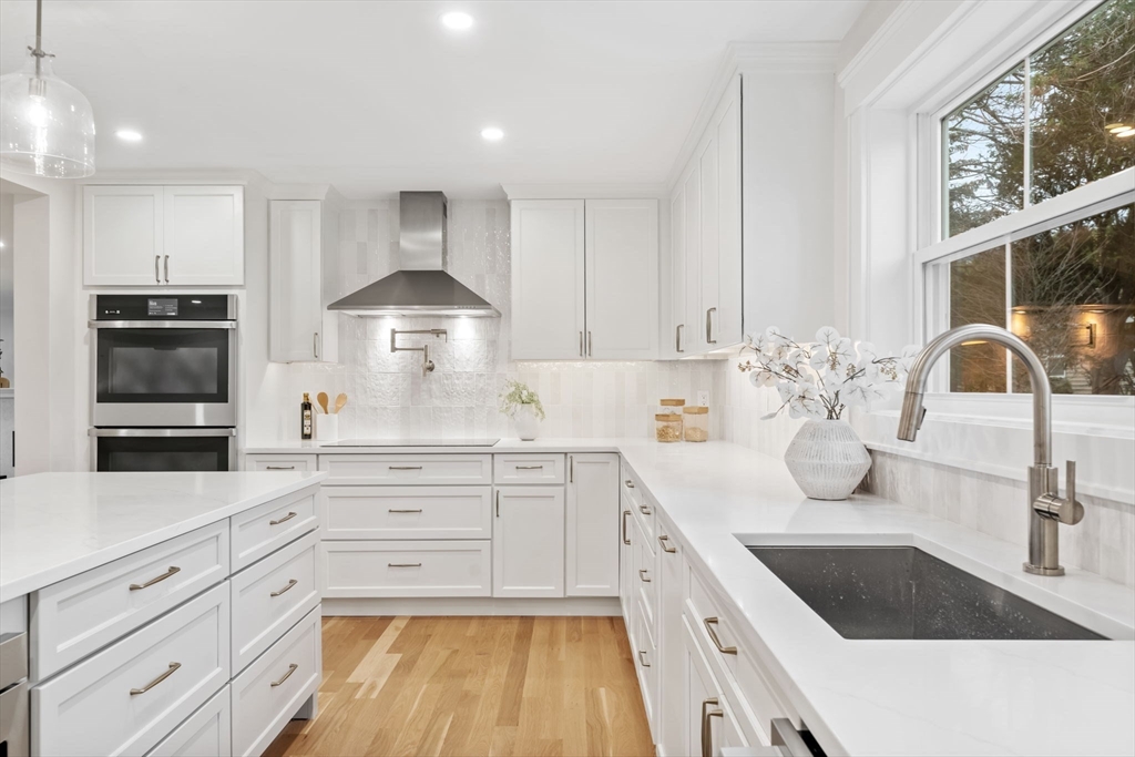56 Valentine Road Arlington, MA 02476 - Photo 19 of 42 a kitchen with granite countertop a sink stainless steel appliances and cabinets