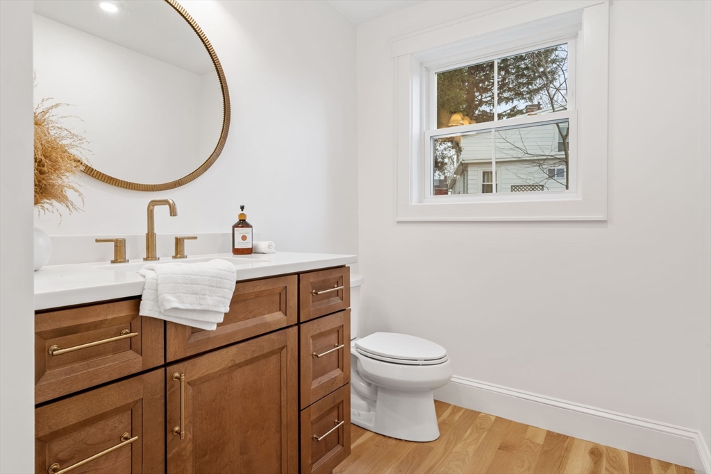 56 Valentine Road Arlington, MA 02476 - Photo 22 of 42 a bathroom with a toilet sink vanity and mirror