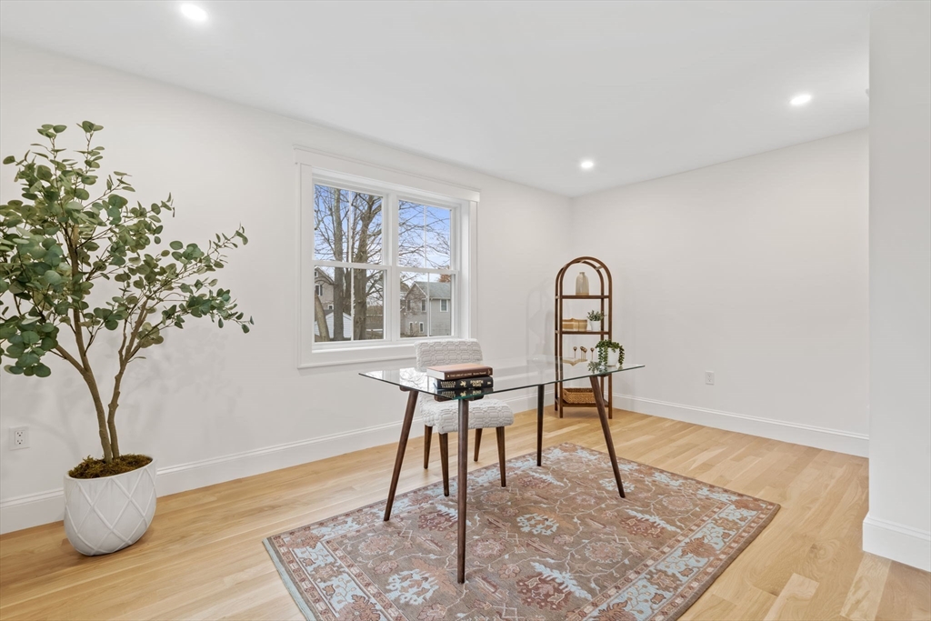 56 Valentine Road Arlington, MA 02476 - Photo 24 of 42 a view of a work space with a potted plant and wooden floor