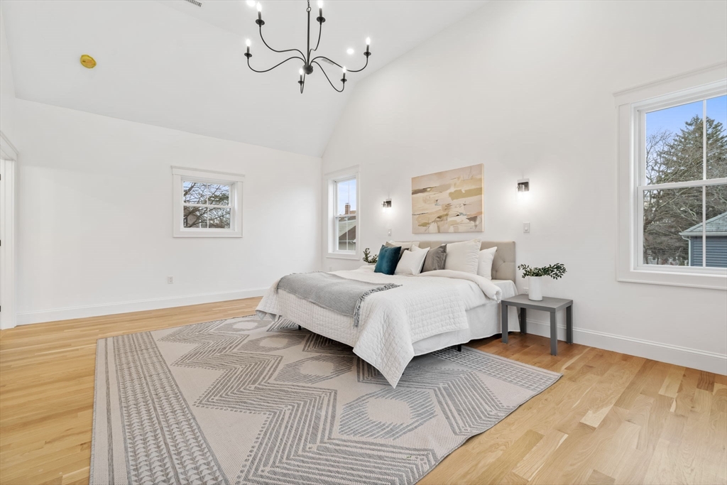 56 Valentine Road Arlington, MA 02476 - Photo 27 of 42 a bed room with a bed mirror and a window