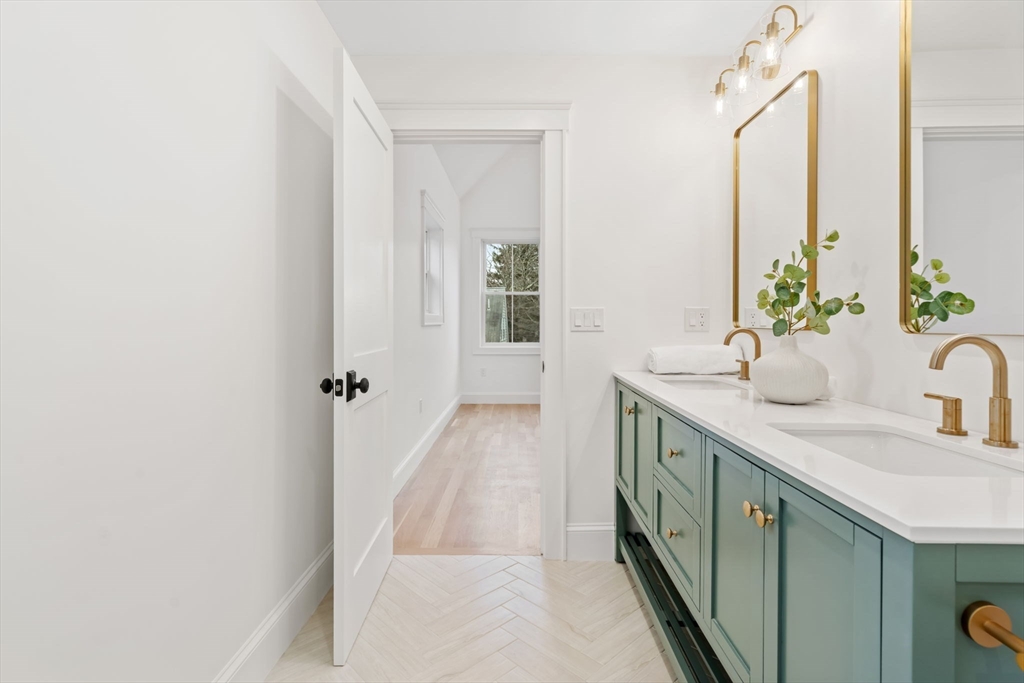 56 Valentine Road Arlington, MA 02476 - Photo 31 of 42 a bathroom with a double vanity sink and a mirror