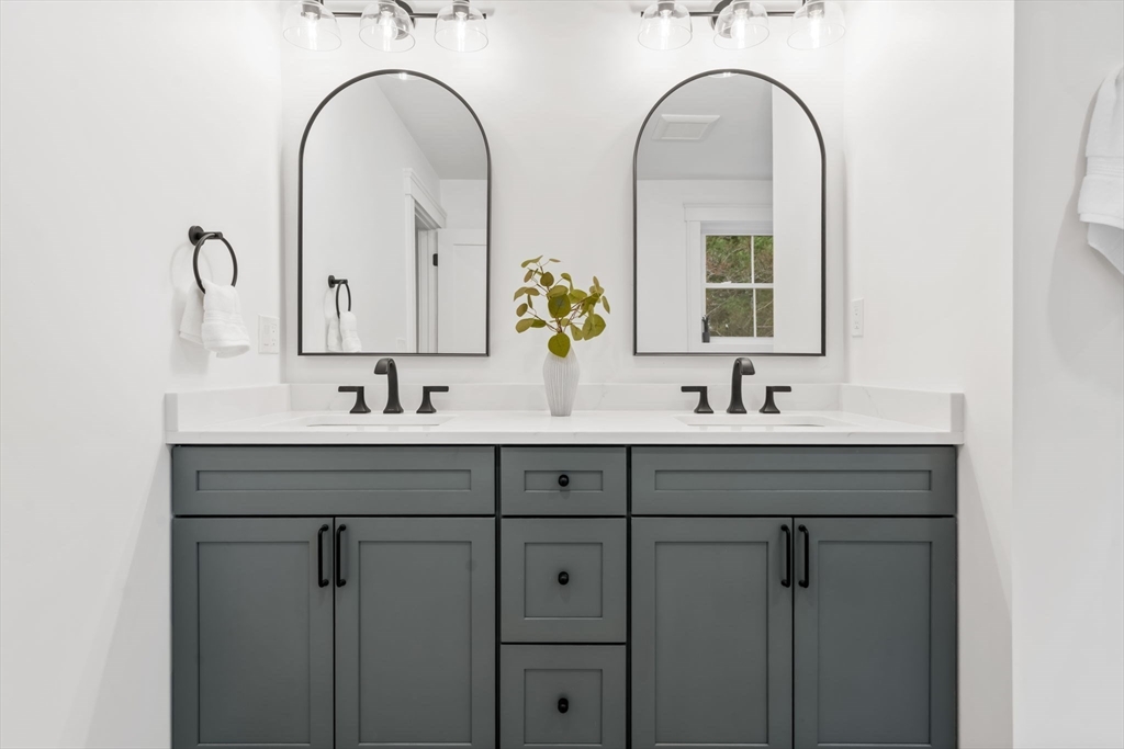 56 Valentine Road Arlington, MA 02476 - Photo 33 of 42 a bathroom with a double vanity sink and two mirror