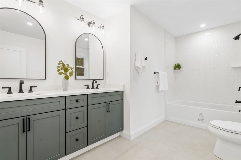 56 Valentine Road Arlington, MA 02476 - Photo 34 of 42 a spacious bathroom with 2 sink toilet and shower