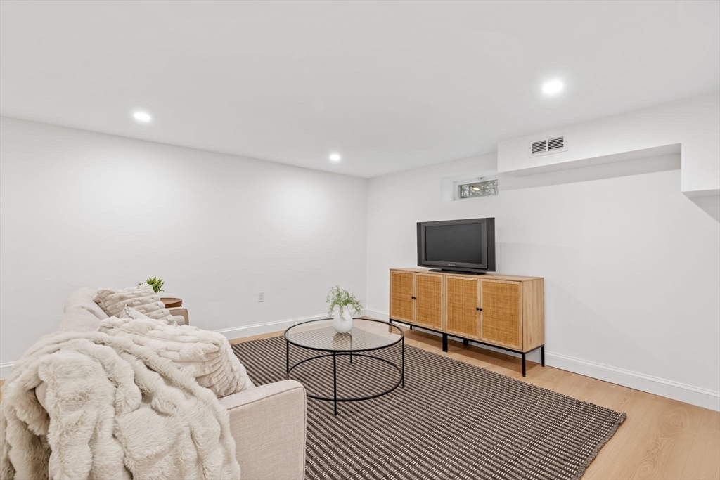 56 Valentine Road Arlington, MA 02476 - Photo 37 of 42 a living room with furniture and a flat screen tv