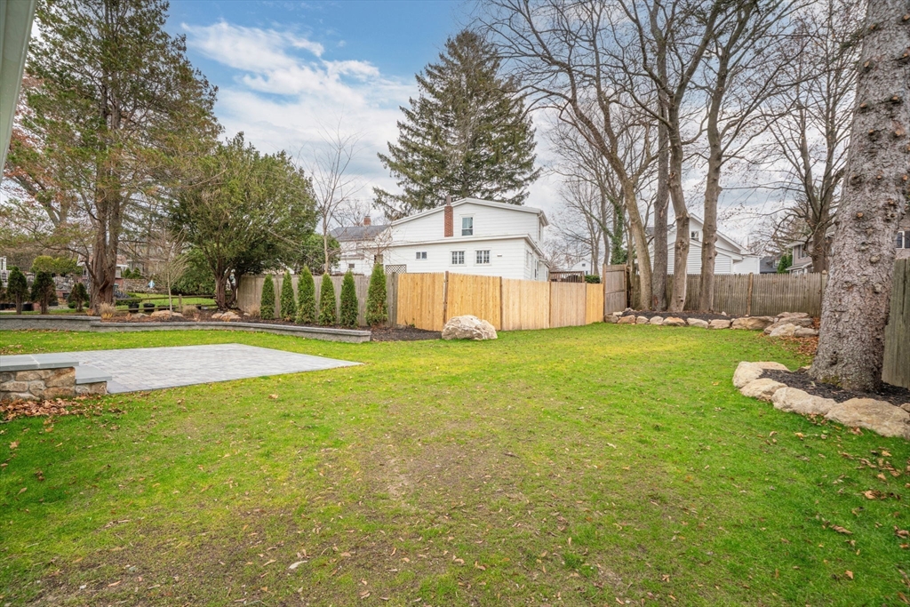 56 Valentine Road Arlington, MA 02476 - Photo 41 of 42 a view of a house with a big yard and large trees
