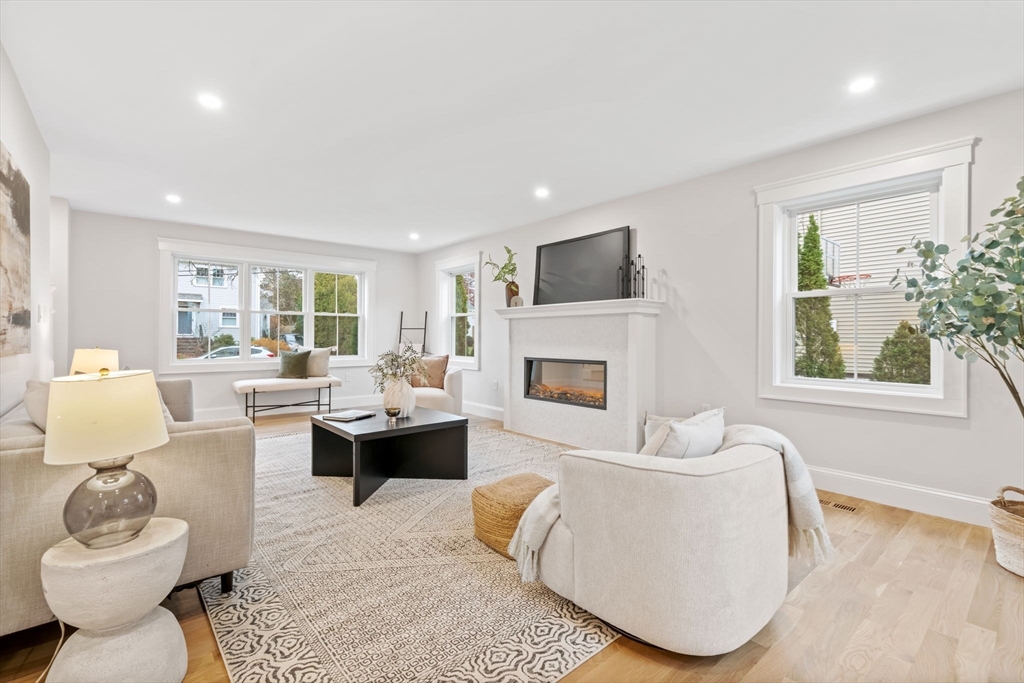 56 Valentine Road Arlington, MA 02476 - Photo 8 of 42 a living room with furniture and a fireplace