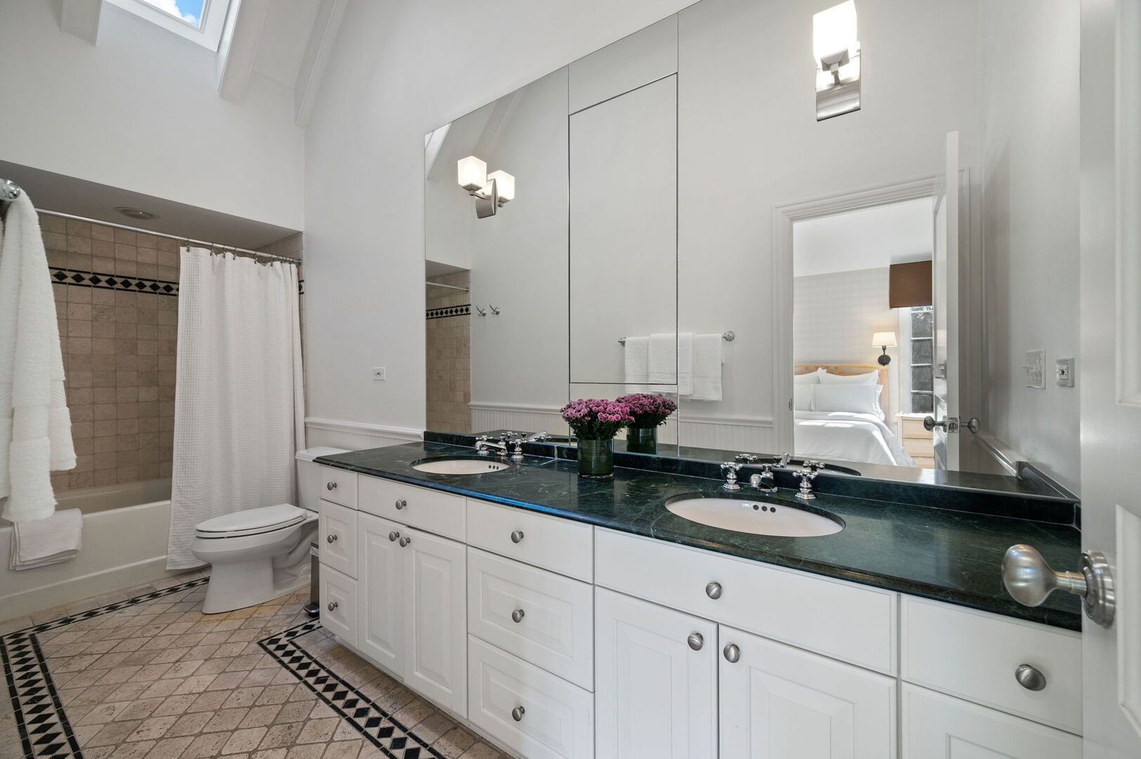 677 Greenleaf Avenue Glencoe, IL 60022 - Photo 29 of 54 a bathroom with a granite countertop sink a toilet and a mirror