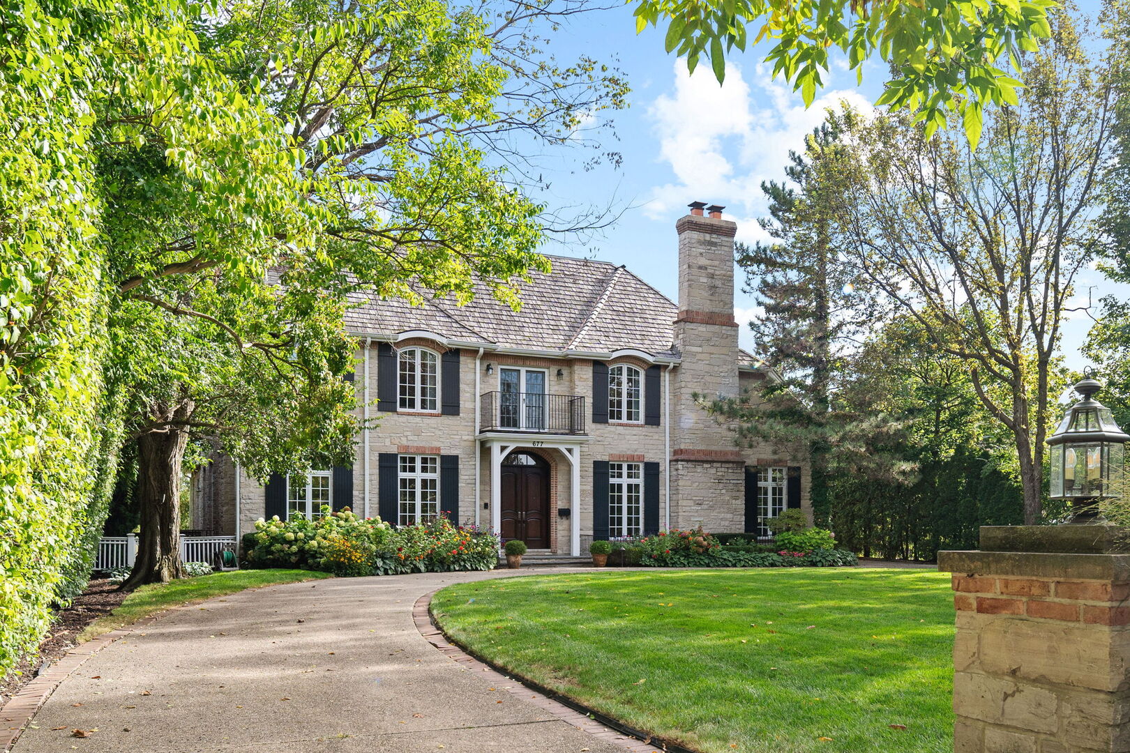 677 Greenleaf Avenue Glencoe, IL 60022 - Photo 4 of 54 a front view of a house with a garden