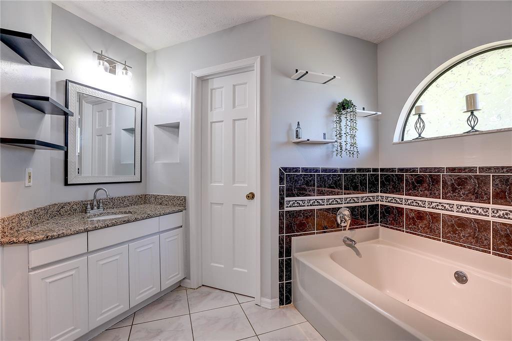 1418 Buckner Road Valrico, FL 33596 - Photo 15 of 37 a bathroom with a tub sink and mirror
