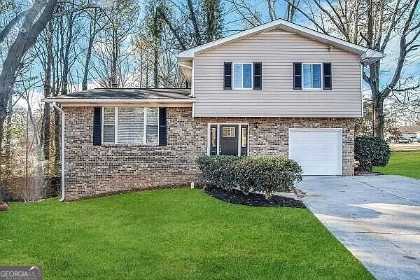 2910 Jerome Road Atlanta, GA 30349 - Photo 1 of 1 a front view of a house with a garden and yard