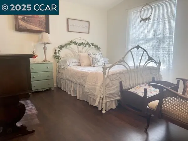 a spacious bedroom with a bed and a dresser
