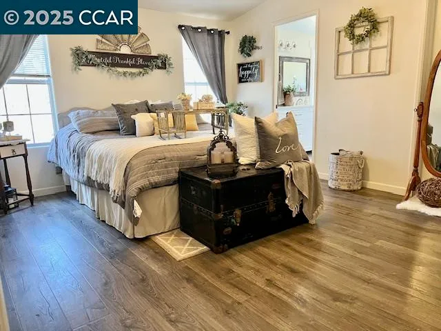 a spacious bedroom with a bed and a dresser