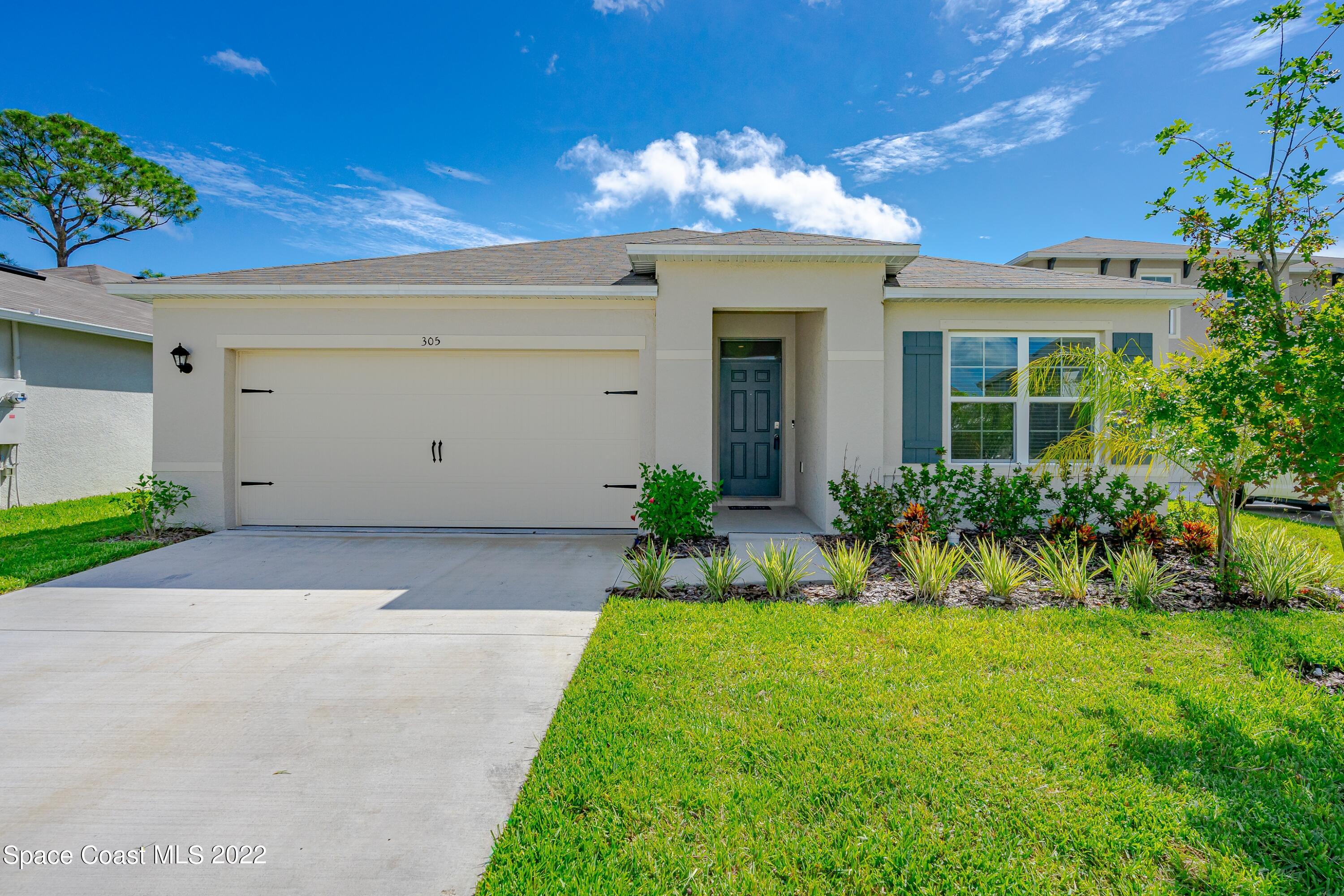 305 Sunset View Drive Edgewater, FL 32141 - Photo 1 of 37 a view of a house with a yard and potted plants