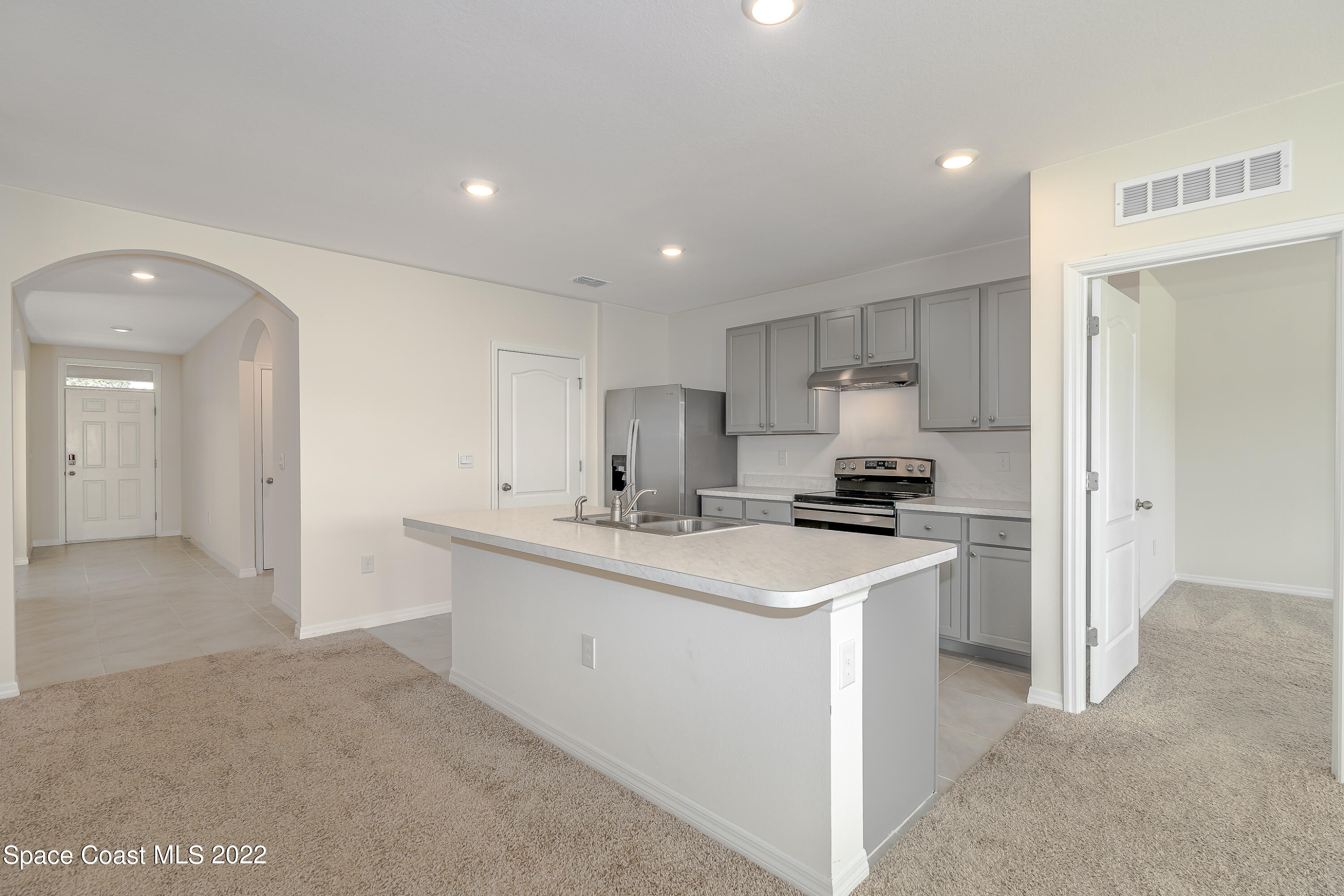 305 Sunset View Drive Edgewater, FL 32141 - Photo 11 of 37 a kitchen with a sink stove and refrigerator